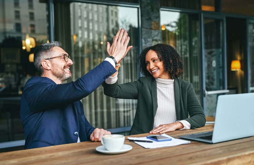 Manager-giving-high-five-to-employee-at-office-favoritism-in-workplace